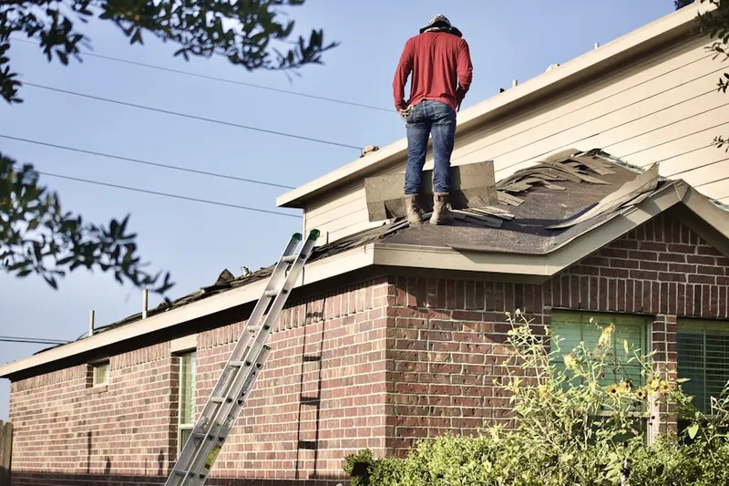 Professional roofer working on a residential roof in Antelope